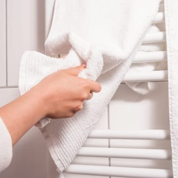 dry hands on a towel, heating in background