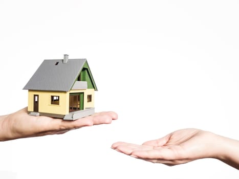 two hands and a house, selling a house, toy house