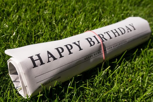 happy birthday newspaper on meadow