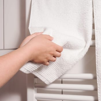 dry hands on towel, heating in background