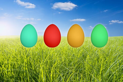 hanging easter eggs and green meadow
