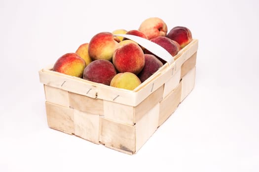 peaches in basket on white background