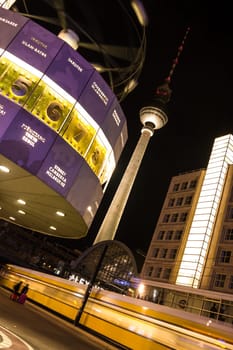 World clock, tv tower and train in berlin by night