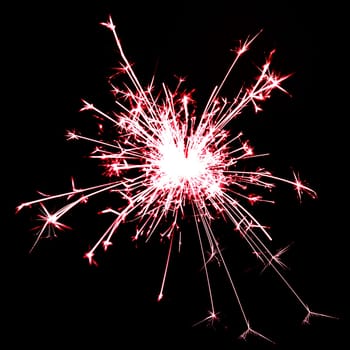 red sparkler on black background
