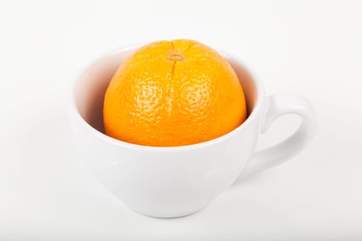 orange in a cup on white