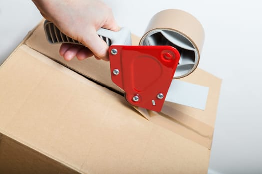Tape Gun Dispenser and a box