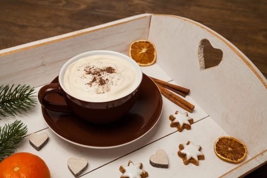 cappuccino and christmas decoration on a tray