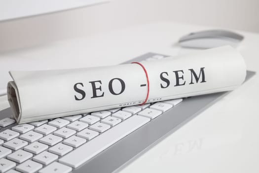 seo sem written on newspaper on computer keyboard