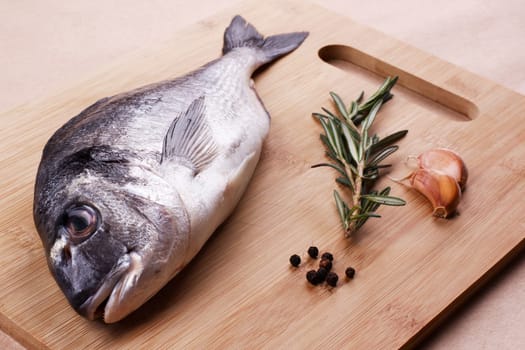 Fresh dorado seafood on a wooden plank - Stock image