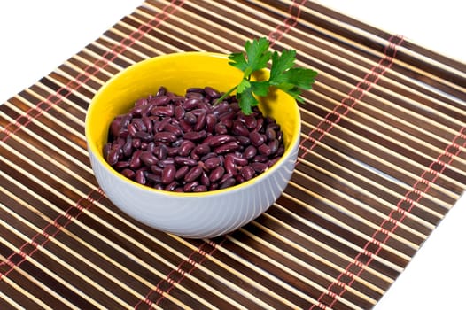 bowl with red beans decorated with parsley, on a rug, isolate, a subject products