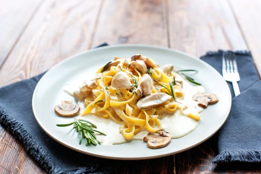 Tagliatelle vegetarian Pasta Dish with Mushrooms on the wooden background