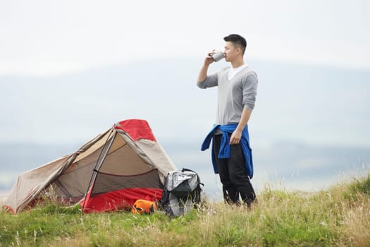 Young Man On Camping Trip In Countryside