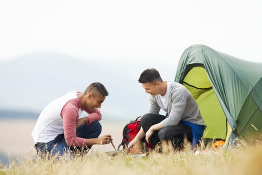 Two Young Men On Camping Trip In Countryside