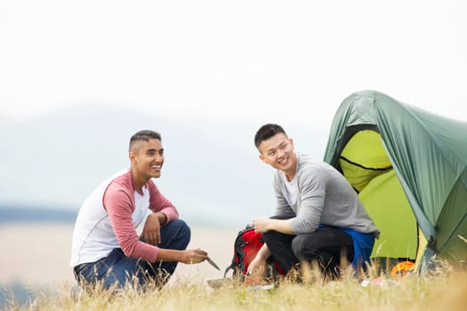 Two Young Men On Camping Trip In Countryside