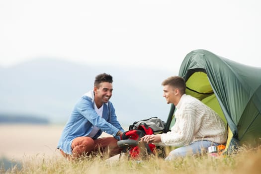 Two Young Men On Camping Trip In Countryside