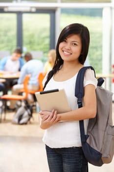 Portrait Of Female Student In Classroom With Digital Tablet