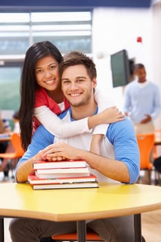 Male And Female Students Studying In Classroom With Books
