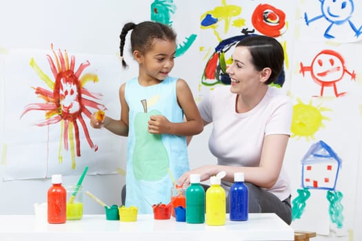 Teacher And Pupil In Pre School Art Class