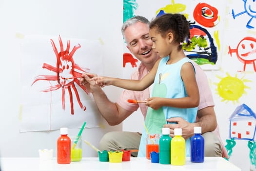 Teacher And Pupil In Pre School Art Class