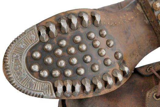 Sole of old military shoes with nails isolated on white background