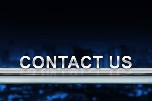 contact us on metal railing with blurred background