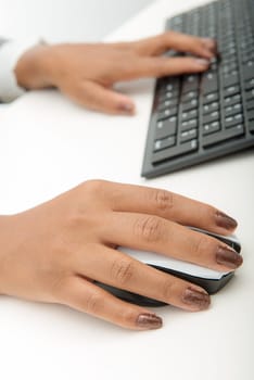 young woman using computer mouse and keyboard