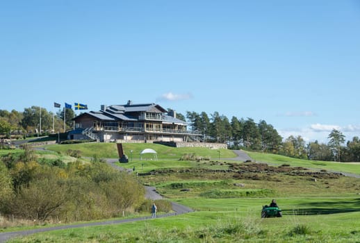 one clubhouse for golf in sweden standing on the top of a hill