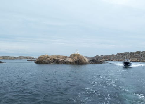 one fast motor boat on sweden westcoast between the rocks