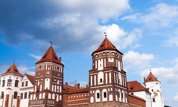 an ancient fortress of the 16th century photographed close-up, located in the town of Mir, Belarus. Summer time of the year, against a blue sky.