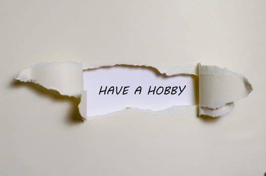 The word have a hobby appearing behind torn paper
