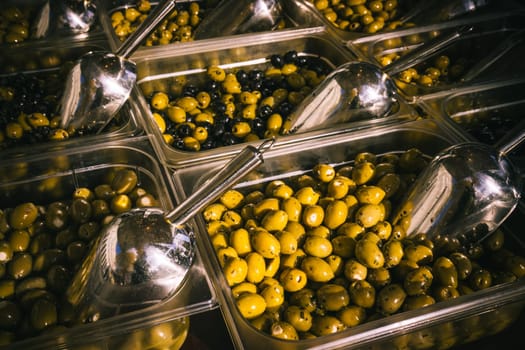 Olives at a market stall. Bowls of olives for sale at a market