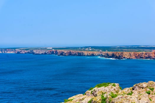 Ocean wave background. Cliff coastline in Sagres, Algarve, Portugal