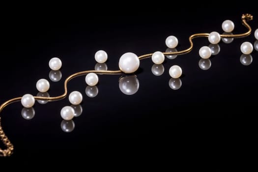 White pearls necklace on black background. Focus on the big pearl!