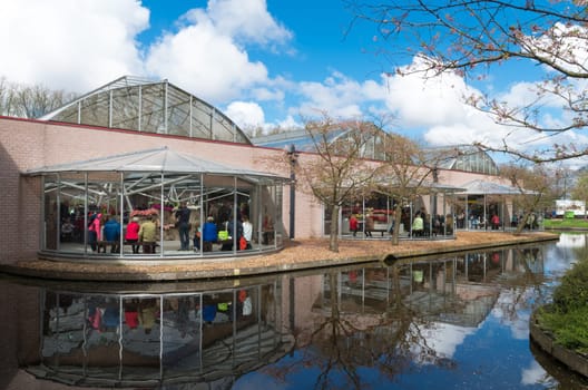 LISSE, NETHERLANDS - APRIL 17, 2016: Exposition building next to a pond in the famous keukenhof tulip gardens in the netherlands