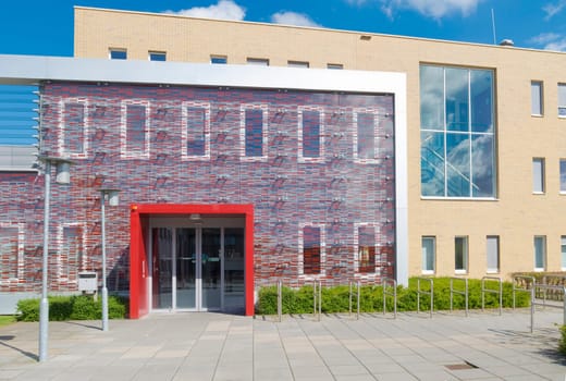 red entrance of a small modern office building