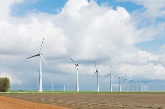row wind turbines in an agricultural dutch landscape