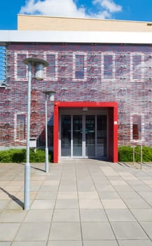 red entrance of a small modern office building