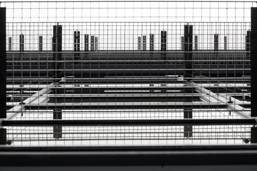 The undersight on overlapping running grids on a window facade.