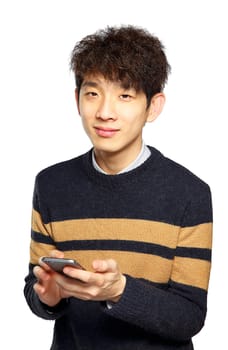 Young man using mobile phone SMS on white background