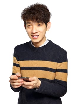 Young man using mobile phone SMS on white background