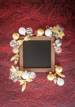 White and golden Christmas baubles on a dark red background