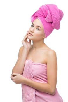 Beautiful young woman with hair and body wrapped in pink towel. Isolated over white background. Copy space.
