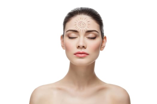 Beautiful young woman with sun shape drawing on forehead. Isolated over white background. Copy space.