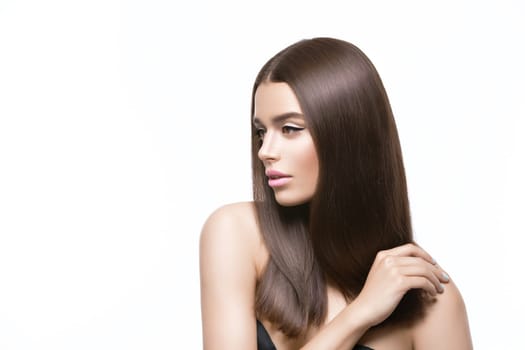 Beautiful young woman with healthy shiny straight hair. Beauty shot. Isolated over white background. Copy space.