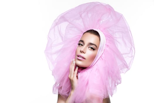 Beautiful young woman in fluffy pink headwear looking to the side. Close up. Beauty shot. Isolated over white background. Copy space.