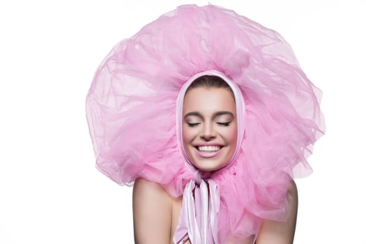 Beautiful happy young woman in fluffy pink headwear. Beauty shot. Isolated over white background. Copy space.