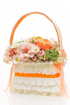 Stylish bridal bouquet made as basket with flowers isolated over white background