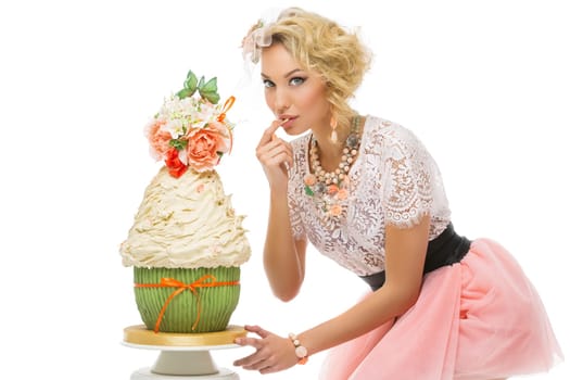 Beautiful young woman tasting stylish wedding cake. isolated over white background