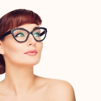 Beautiful young woman with red hair and makeup in glasses Beauty shot. Isolated over white background. Copy space.