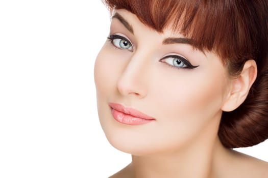 Beautiful young woman with red hair, makeup and smooth skin. Isolated over white background. Copy space.